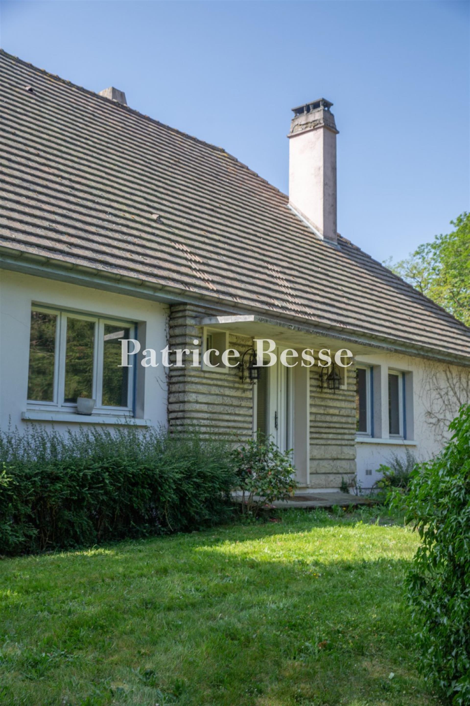 A comfortable house from the 1960s on a large wooded property, perched on a plateau overlooking the