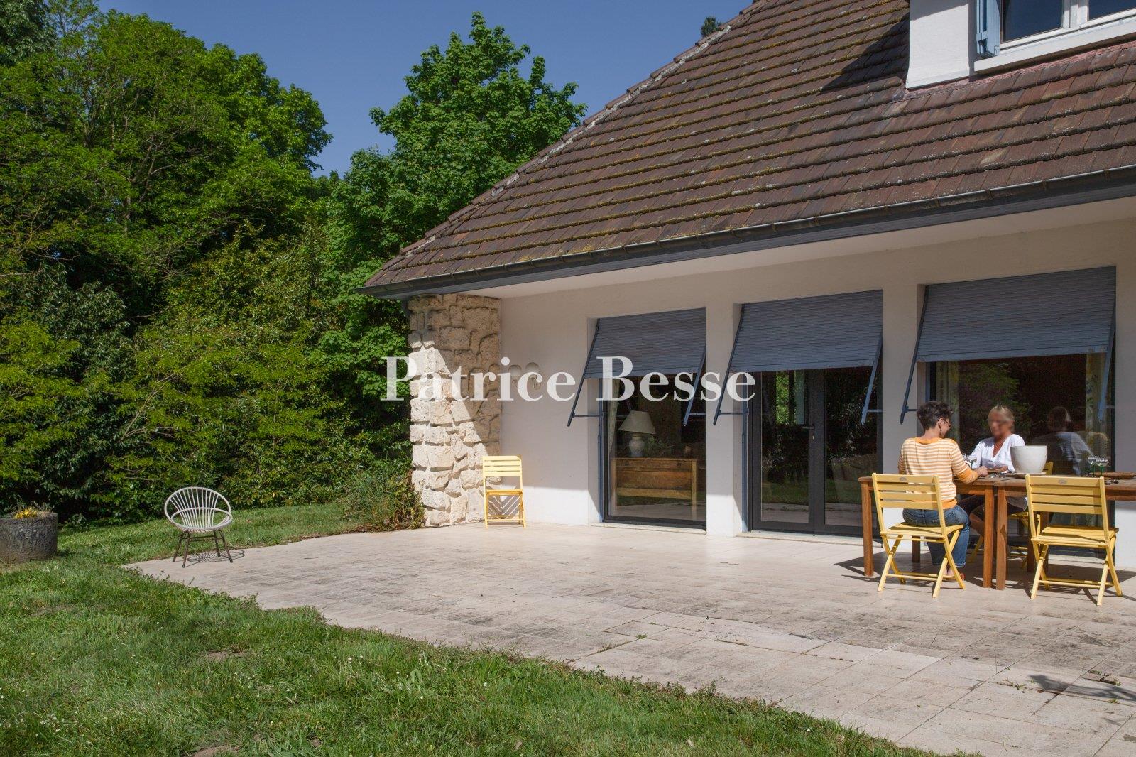A comfortable house from the 1960s on a large wooded property, perched on a plateau overlooking the