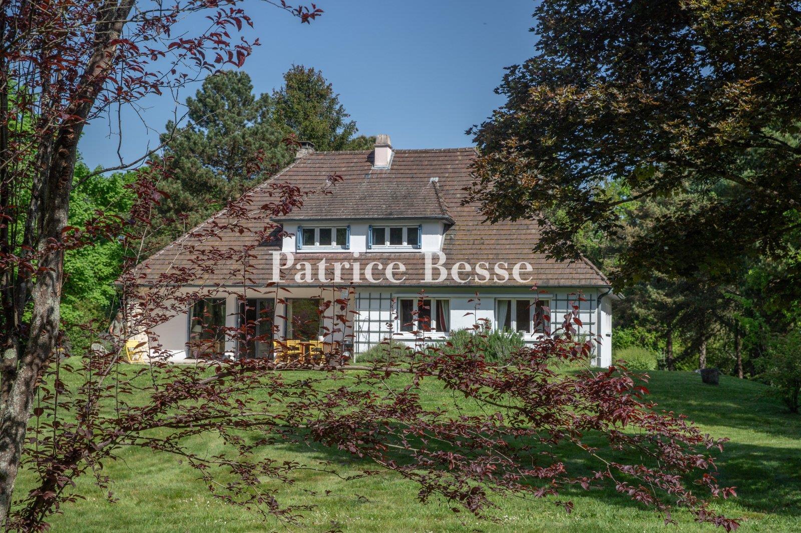 A comfortable house from the 1960s on a large wooded property, perched on a plateau overlooking the