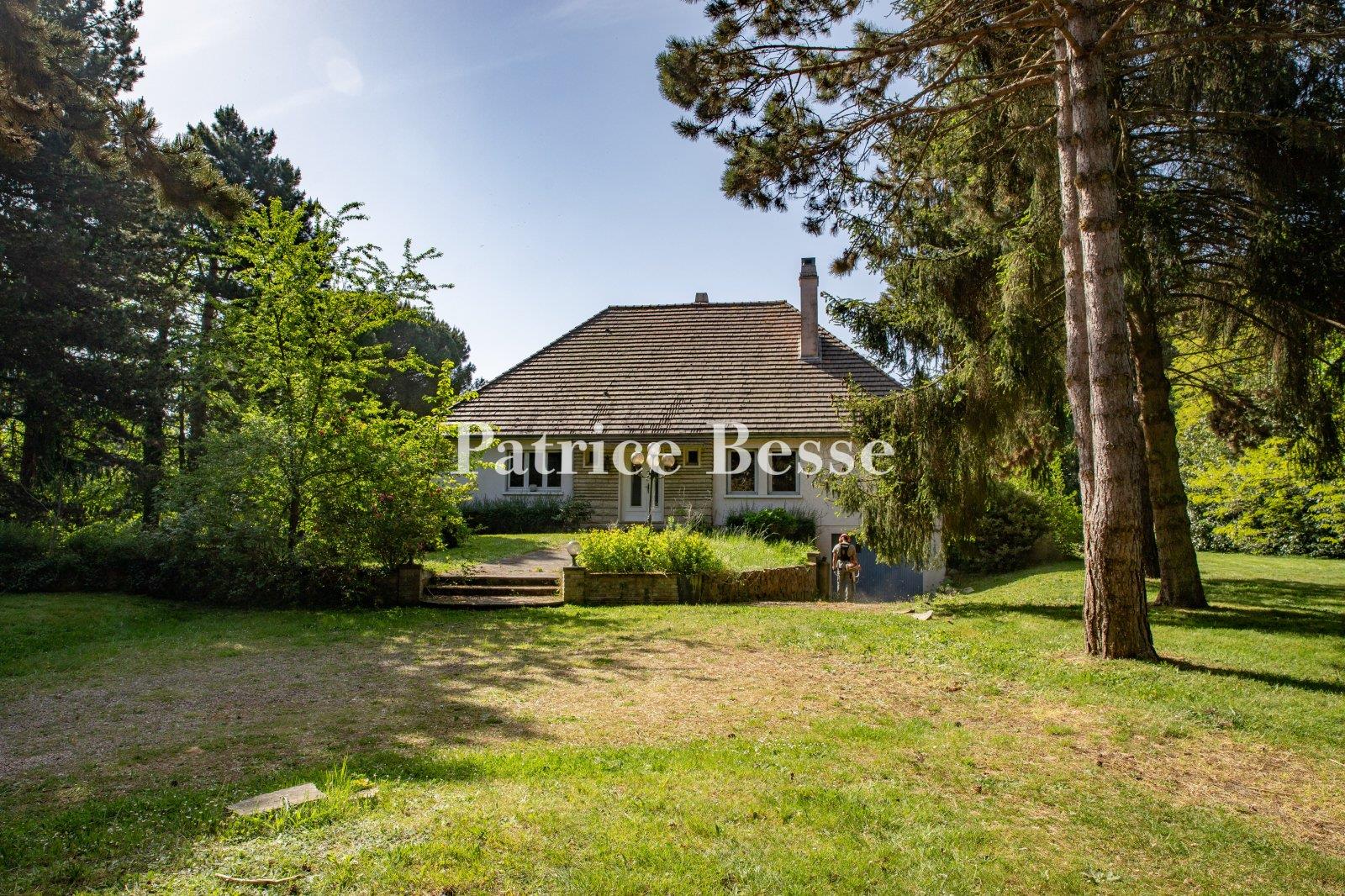 A comfortable house from the 1960s on a large wooded property, perched on a plateau overlooking the