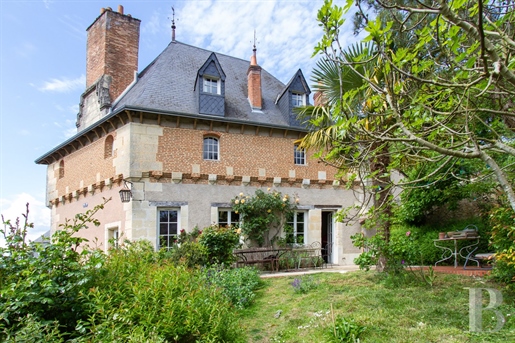 A 15th century house surrounded by its gardens, courtyard and meadow, in a village less than half an