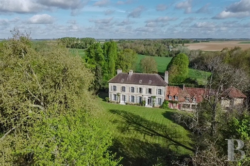 A beautiful property near Paris with vast, tree-dotted grounds, an 18th-century house and a 17th-cen