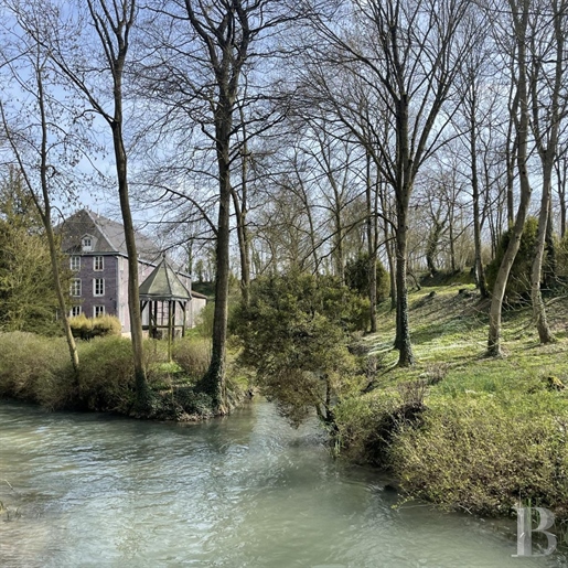 A large watermill nestled in the valley of the River Moivre in France's Champagne region.