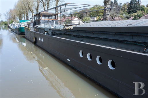 A barge designed by the famous architect Jean Nouvel in 1991, moored in a marina in Burgundy, less t