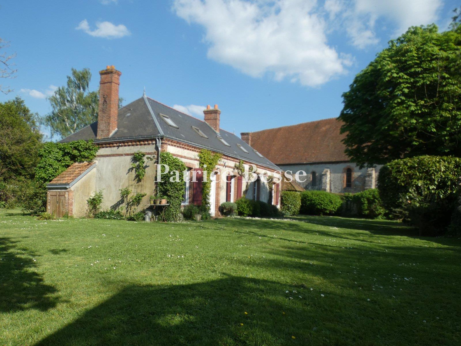 A charming renovated presbytery, its outbuildings, enclosed garden and views of the surrounding fiel