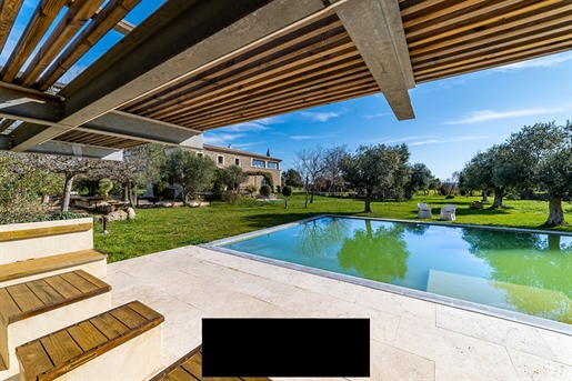 At the gates of Uzes, this elegant stone house in the &quot Magnanerie&quot style and its landscaped