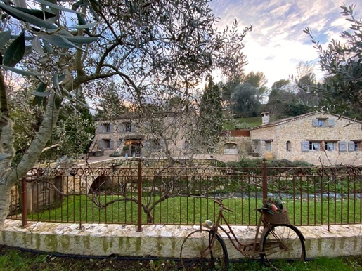 Nestled along a serene riverbank, this charming 18th-century olive mill has been thoughtfully restor