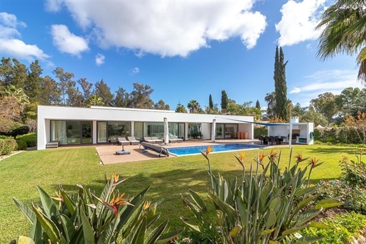 Modern and luxurious four-bedroom villa with golf course views.
