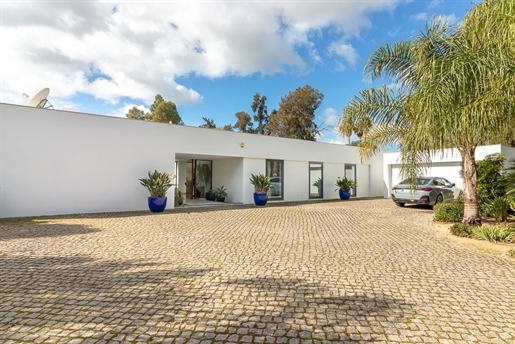 Modern and luxurious four-bedroom villa with golf course views.