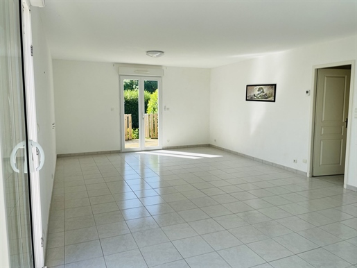 Recent house with garage and garden with trees