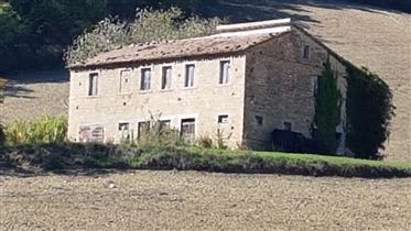 Beautiful stone cottage completely to be restored with outbuildings and arable land