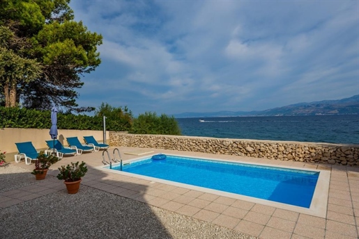 Beachfront villa decorated with traditional stone, with swimming pool, on magic Brac island
