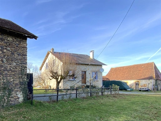 Ensemble of a restored country house with barn with a farmhouse to renovate and outbuildings on more
