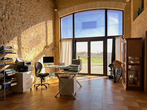 This renovated stone barn offers a professional commercial space including offices and a wine making