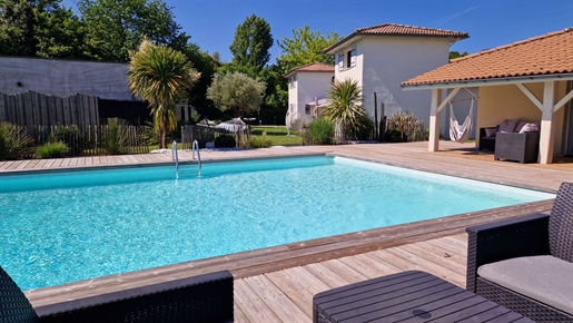Villa with landscaped garden, pool, cellar, holiday cottage, and guest room.