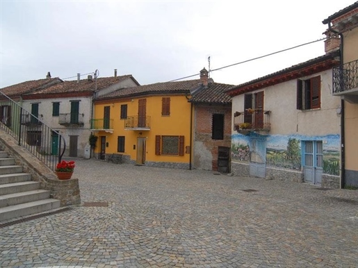 Overlooking the main square of Roddino, a large village house in need of restoration
