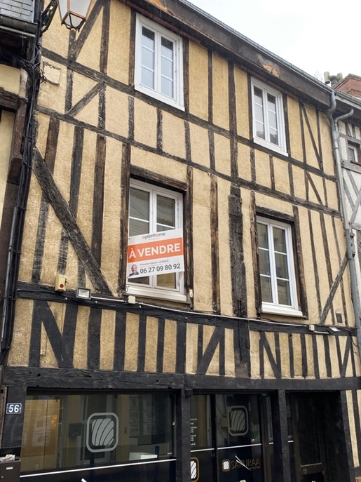 Half-Timbered semi-detached house well placed in Bernay town center with a commercial space on the g